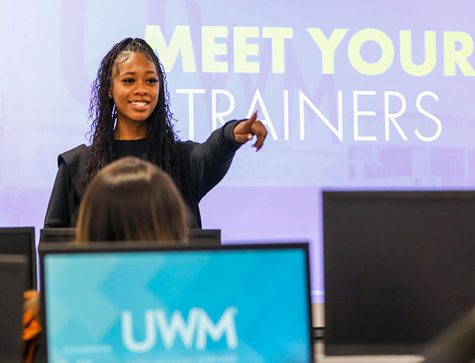 A happy professional taking a question from a training group