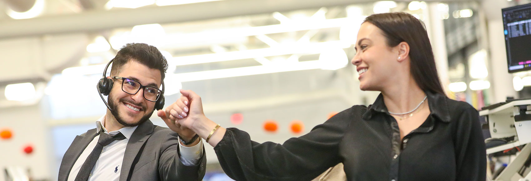 Landing page banner showing two UWM Team members with the Sales team smiling and bumping fists