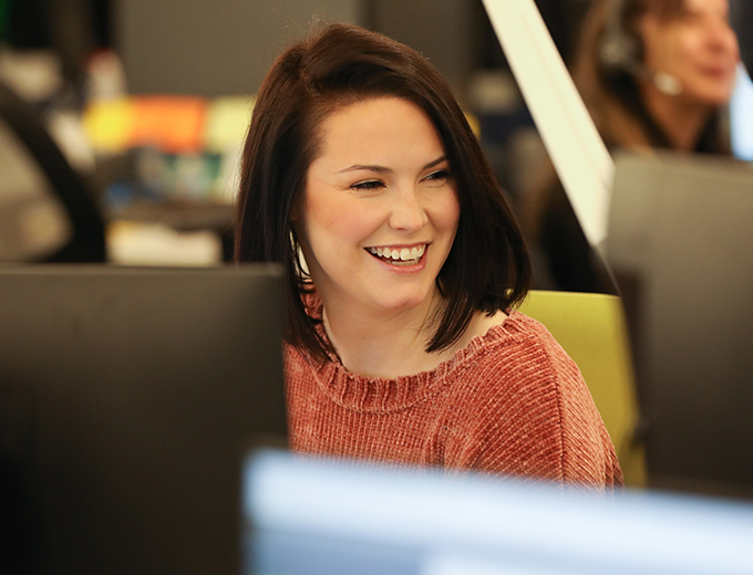 Happy young professional at their desk