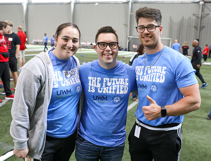 Three happy professionals in the UWM Sports complex