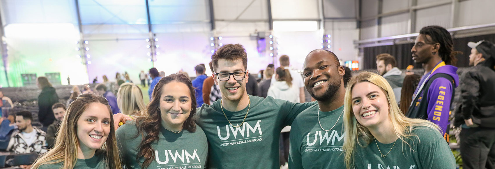 Landing page banner depicting several team members smiling at a UWM event