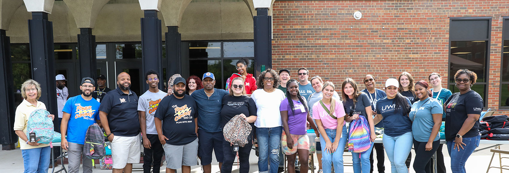 Landing page banner showing several team members hard at work with community service using the UWM-provided volunteer paid time off