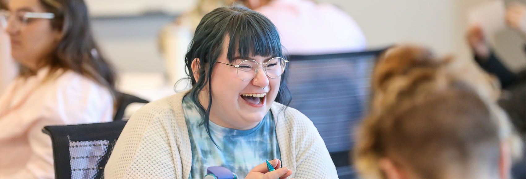 Landing page banner depicting UWM team members laughing together