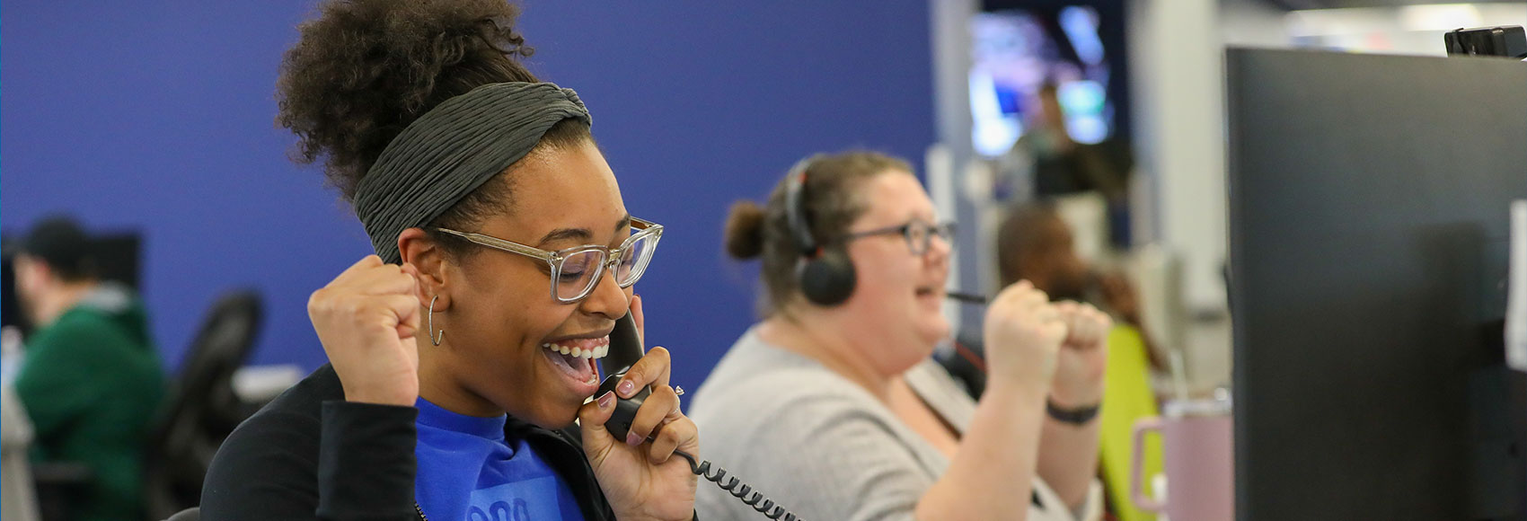 Landing page banner depicting happy UWM team members taking phone calls