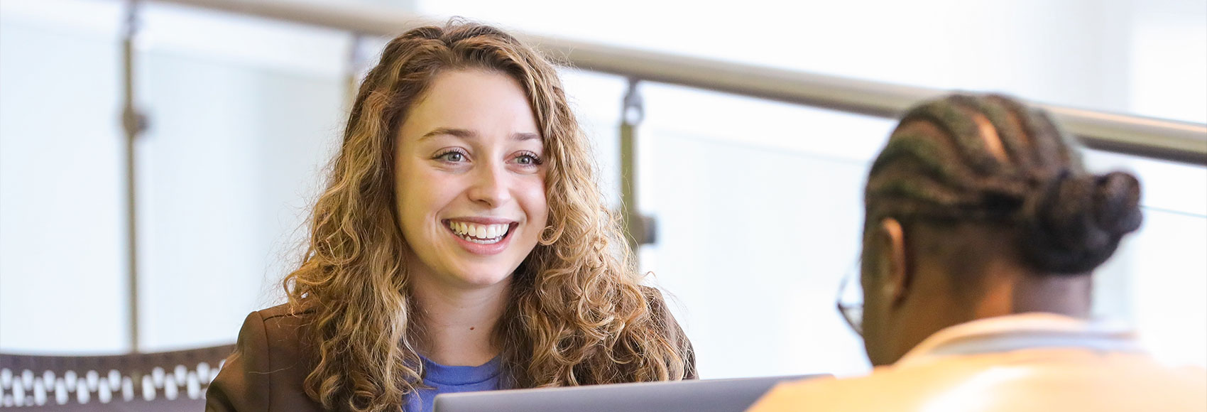 Landing page banner of a happy UWM team member