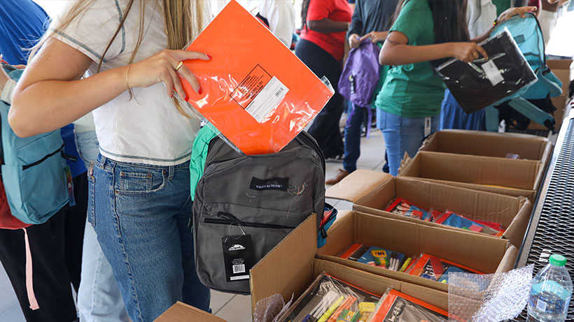 UWM team members showing the donations they helps provide