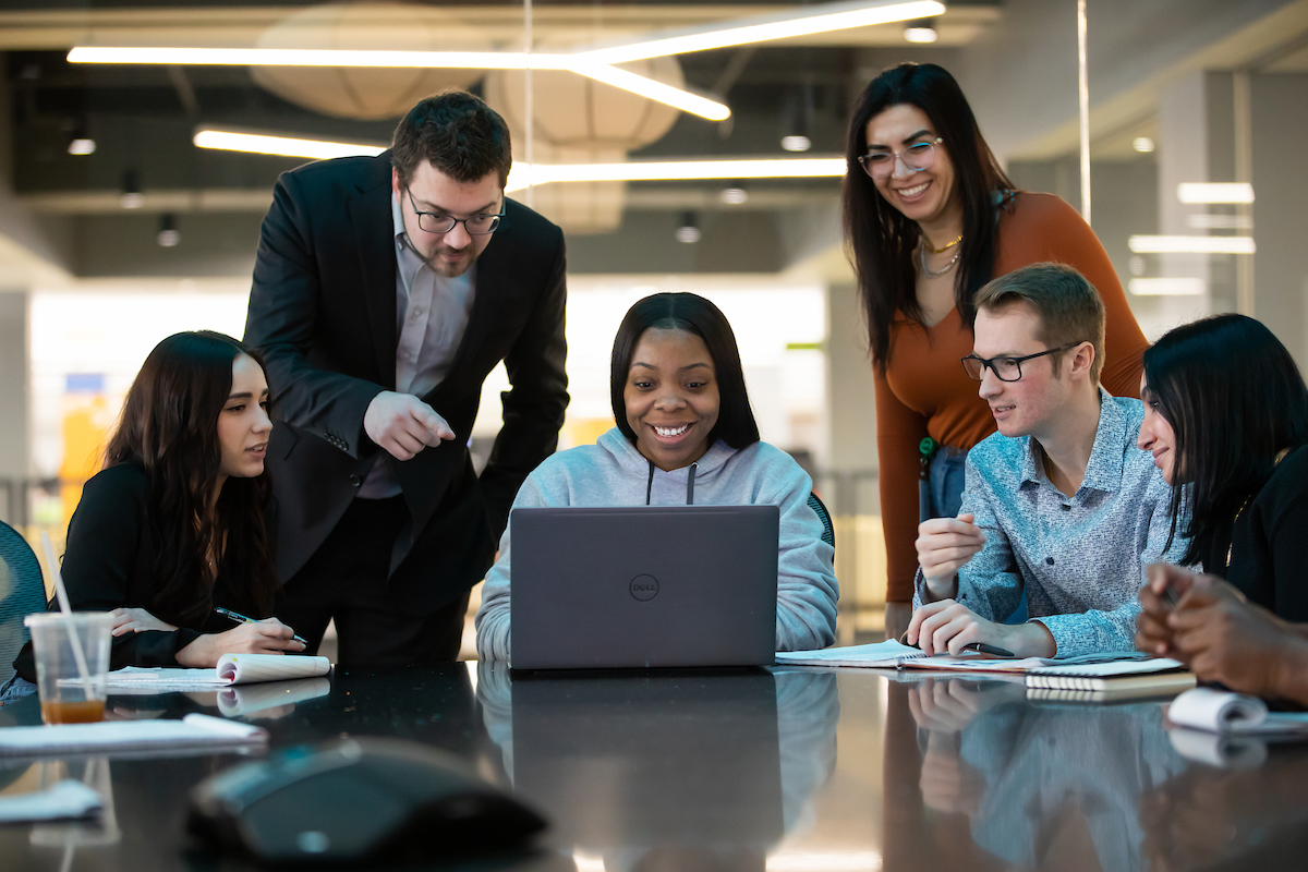 UWM team members surrounding a computer